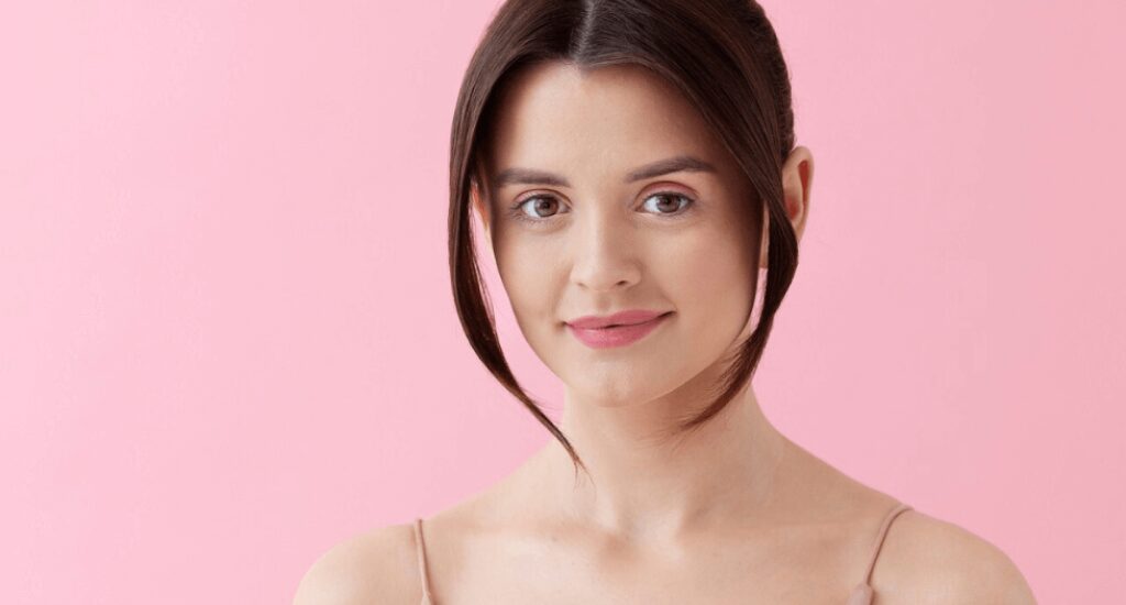 Hairstyle maintenance showcasing a woman with a clean center-parted haircut framing an oval face shape.